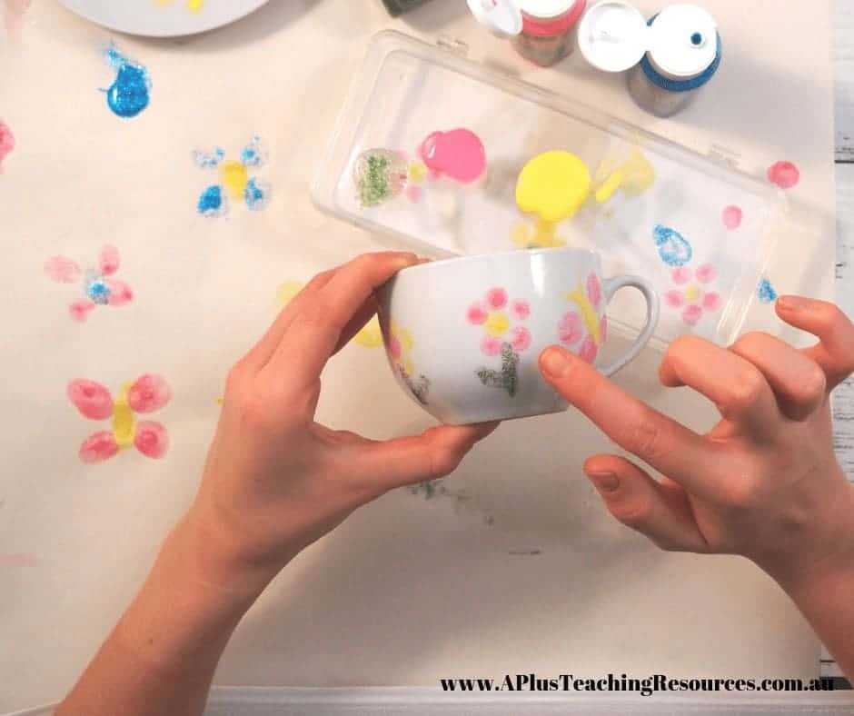 Image of gir making fingerprints on a Mothers day tea cup present 