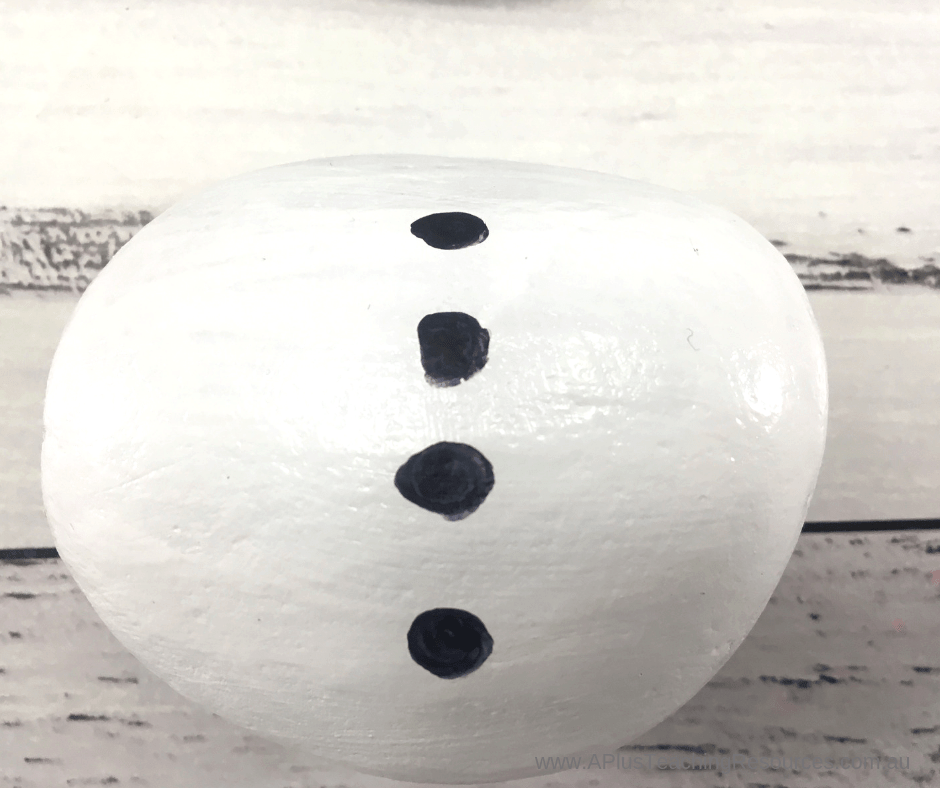 paint buttons onto body of rock snowman